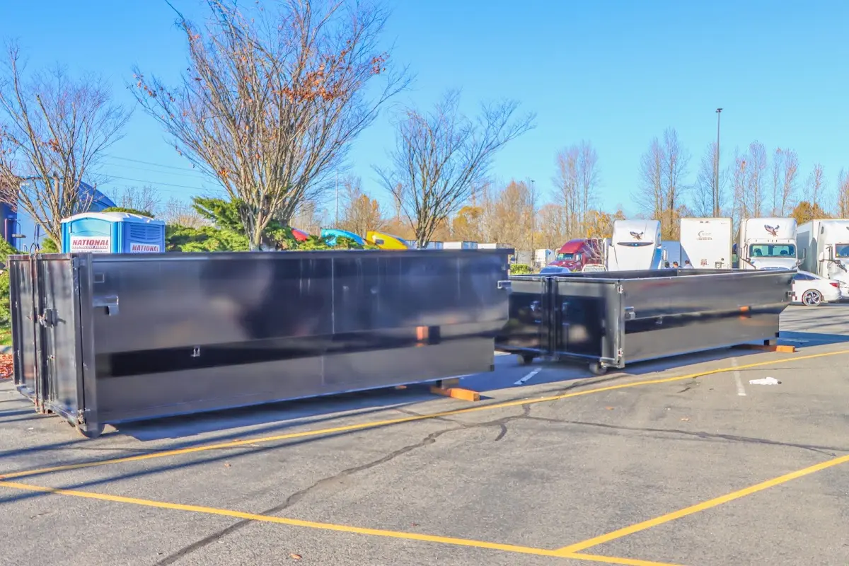 Professional dumpster rental service with roll-off container on residential driveway in Hammond